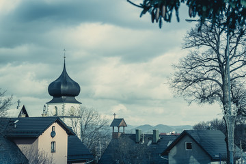 Church tower and homes rooftops in Karpacz