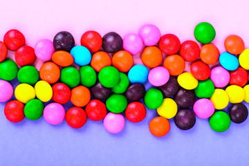 Small colored candy on bright background