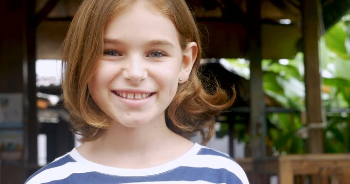 Portrait of a beautiful young happy confident 11 - 12 year old girl smiling
