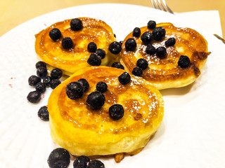 Breakfast for child. Delicious sweet pancakes with syrup, blueberries