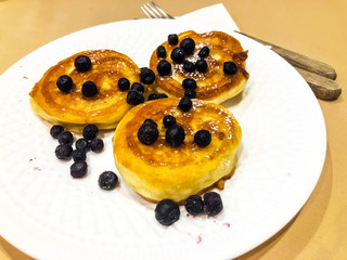 Breakfast for child. Delicious sweet pancakes with syrup, blueberries