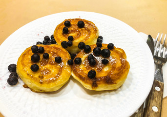 Breakfast for child. Delicious sweet pancakes with syrup, blueberries