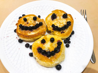 Breakfast for child. Delicious sweet pancakes with syrup, blueberries