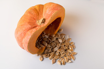 Orange pumpkin with seeds, on white background.