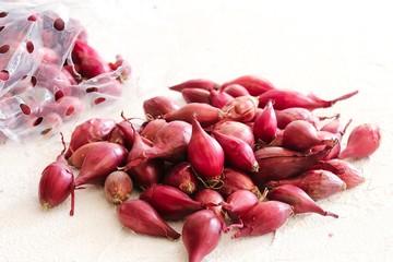 Small pearl onions on white background, selective focus