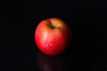 Red apple on a black background.
