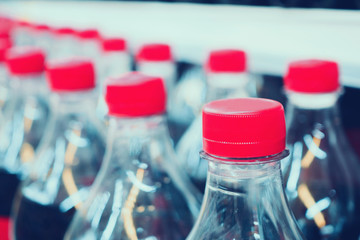 soft drinks bottles on shelves in supermarket