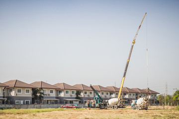 Fototapeta premium House building at construction site with crane truck