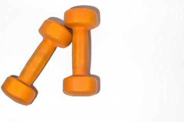Orange dumbbell on white background close up