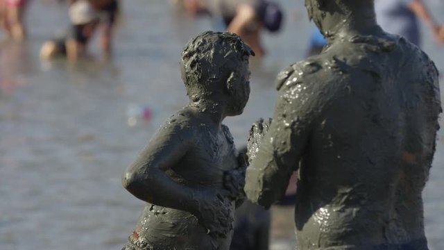 People cover themselves in mud