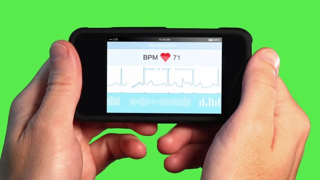 A man holds a handheld device or smartphone that monitors his EKG. Green screen, EKG and screen animation simulated.  	