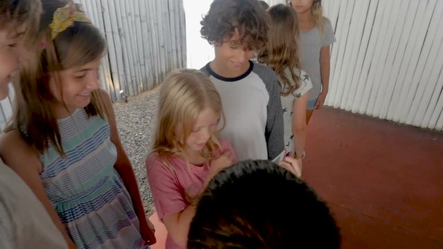Group of young pre teenage children watching a tablet together