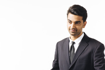 Man in business suit and tie looking to side , isolated on white studio background