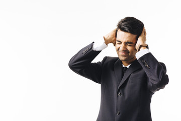 Unhappy businessman holding his head, isolated on white studio background