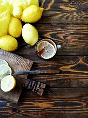 tea with lemons in a rustic forest style on wooden background with old knife and wooden cutting Board 