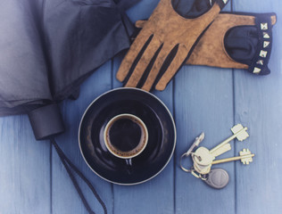 keys to the house, gloves, umbrella and a cup of coffee