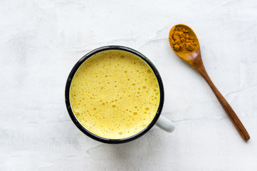 Turmeric latte, Golden milk. Hot healthy drink. Concrete background. Top view. 