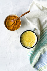 Turmeric latte, Cooking Golden Milk On Kitchen. Hot healthy drink. Concrete background. Top view. 