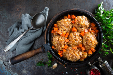 Veal meatballs stewed in frying pan with carrot in vegetable sauce. Delicious meat dish