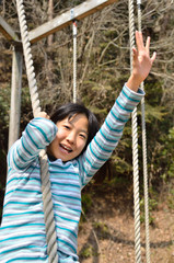 公園の遊具で遊ぶ女の子