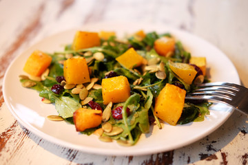 salad with pumpkin, pumpkin seeds and arugula
