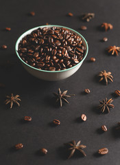 Coffee beans in a bowl with natural lighting on a black backgound