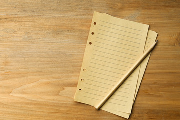 pencil and vintage paper on wooden table