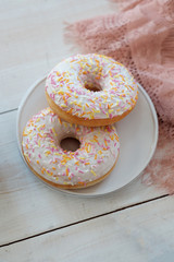 Donuts with icing on pastel background. 