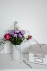 A bouquet of flowers in a jug