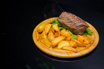 Tender and juicy veal steak medium rare with French fries.