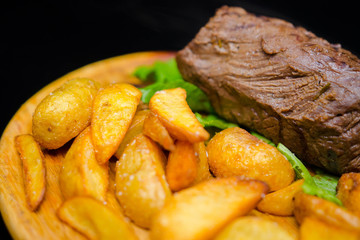 Tender and juicy veal steak medium rare with French fries.