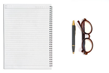 Notebook ,pen and glasses on isolated white background
