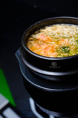 Tasty miso soup with salmon on black rock.