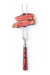 Fotobehang Steakhouse Slices of beef steak on meat fork on white background