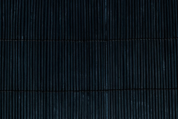 Black Bamboo Mat on Dark Background Tied Up With the Rope