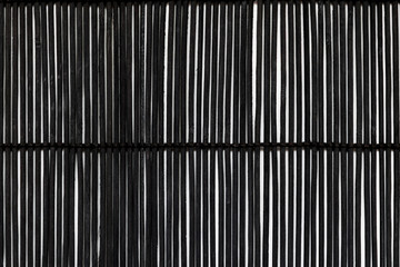 Black Bamboo Mat on White Background Tied Up With the Rope