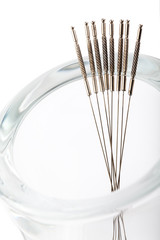 Silver needles for traditional Chinese acupuncture medicine. Isolated white background. There is room for your text or sign.