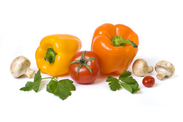 The yellow and orange peppers with tomatoes on a white background. Multicolored vegetables in a composition on a white background..