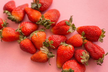 background from freshly harvested strawberries, directly above, pink background