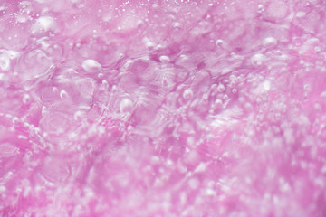 Close up of Air Bubbles in Ice on Pink Background