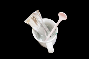 packaging aluminum foil coffee stick pouch and cup isolated on black