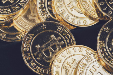 Conceptual image for worldwide cryptocurrency, huge stack physical version of golden Bitcoin