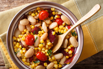 organic salad succotash from the butter beans, tomatoes and bacon close up in a bowl. horizontal top view