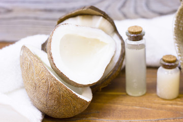Natural herbal skin care products, top view ingredients coconut, essence oil on table concept of the best all natural face moisturizer. Facial treatment preparation background