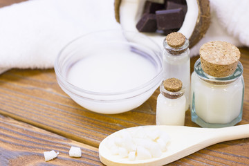 Natural herbal skin care products, top view ingredients coconut, essence oil on table concept of the best all natural face moisturizer. Facial treatment preparation background