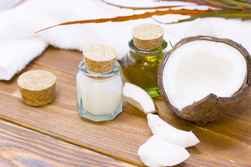 Natural herbal skin care products, top view ingredients coconut, essence oil on table concept of the best all natural face moisturizer. Facial treatment preparation background