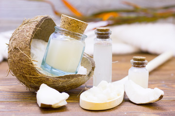 Natural herbal skin care products, top view ingredients coconut, essence oil on table concept of the best all natural face moisturizer. Facial treatment preparation background