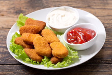plate of chicken nuggets on wooden table