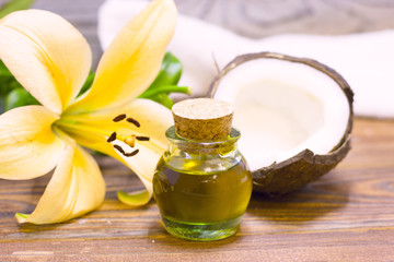 Natural herbal skin care products, top view ingredients coconut, lily flower, essence oil on table concept of the best all natural face moisturizer. Facial treatment preparation background
