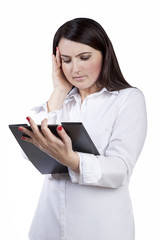 Businesswoman with headache looking on contract. Isolated on white background